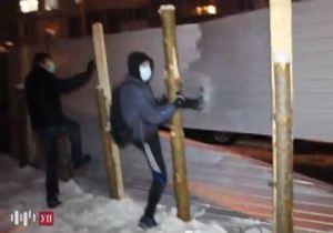 В Киеве 150 молодых людей сломали забор вокруг стройки на Троещине. Кадр с видео.