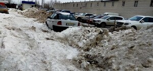 Обленились: на Троещине снег с платной парковки перебросили на бесплатную